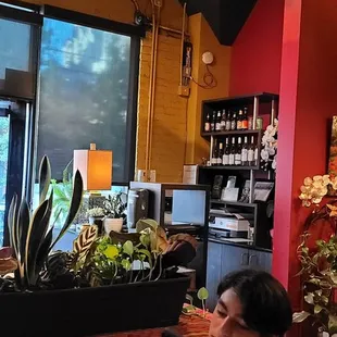 a woman sitting at a table looking at her phone