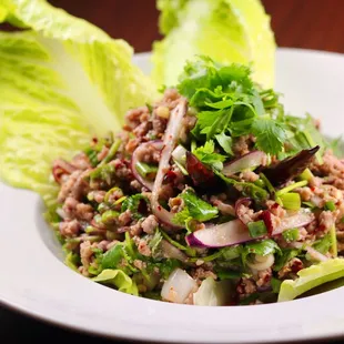 a plate of salad with lettuce