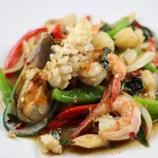 a plate of stir fried shrimp and vegetables