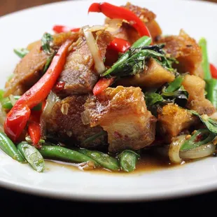 a plate of stir fried meat and vegetables