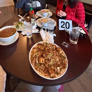 two people sitting at a table with food