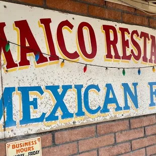 a mexican food restaurant sign on a brick wall