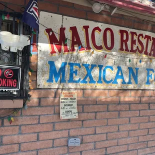 a mexican food restaurant sign on a brick wall