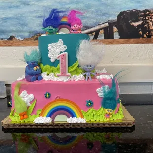 a cake decorated with a rainbow