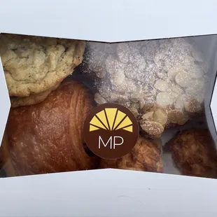 (Upper left, clockwise) salted chocolate chip, almond croissant, coconut macaroons and chocolate croissant