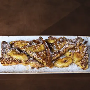 a plate of french toast with powdered sugar