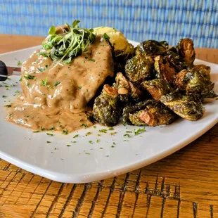 Beef tenderloin steak topped with a house made cognac sauce, served with mashed potatoes and brussel sprouts.