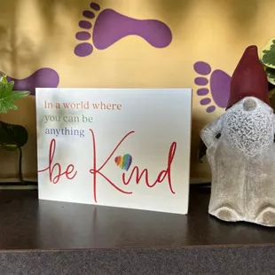 a sign that says be kind