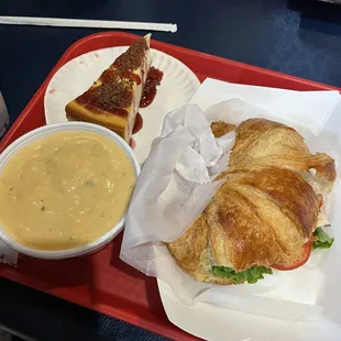 Blue plate special (chicken salad on a croissant with a slice of cheesecake) with a side of au gratin potato soup.
