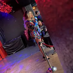 a woman in a colorful dress on a stage