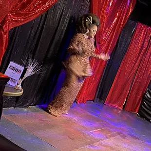 a woman in a costume on stage