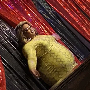 a woman in a yellow dress on stage