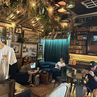 people sitting at tables and working on laptops