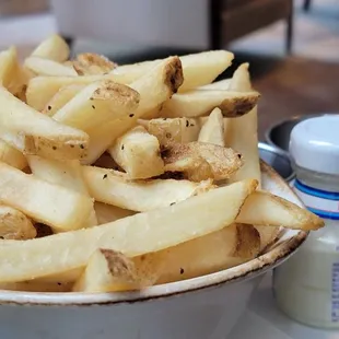 a bowl of french fries on a plate