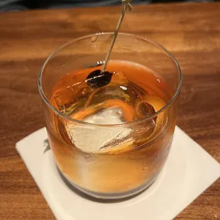 a drink in a glass with a spoon sticking out of it