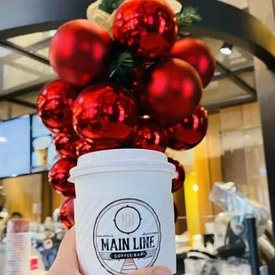 a hand holding a cup of coffee