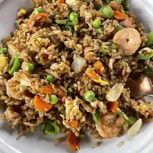 a plate of fried rice with shrimp and vegetables