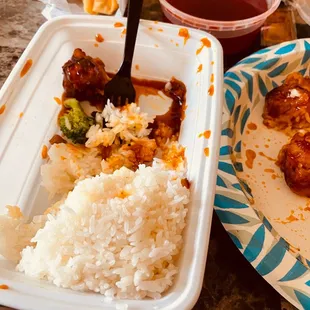 a plate of rice, meatballs, and sauce
