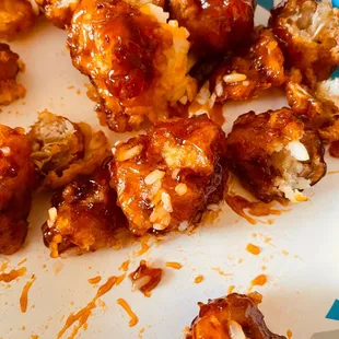 a plate of chicken wings covered in bbq sauce
