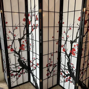 a room divider with red flowers