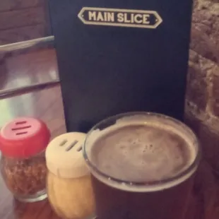 a pint of beer and salt on a table