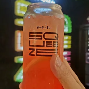 a person holding a glass of iced tea