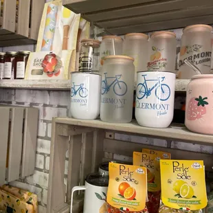 a shelf full of coffee mugs and other items