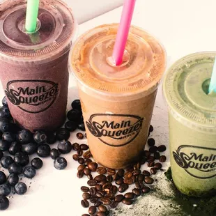 three smoothie drinks with blueberries and coffee beans