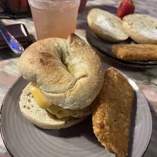 Plant based sausage and dairy free cheese on a sourdough bagel
