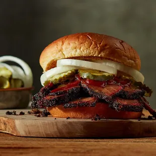 ows a beef sandwich with pickles and onions