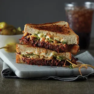 ows a grilled cheese sandwich with pickles and pickles