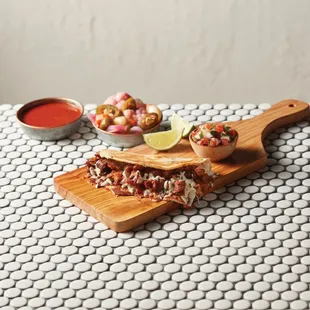 ows a grilled meat sandwich on a cutting board