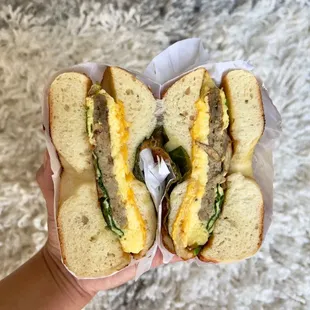 a hand holding a sandwich