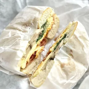 Scored Garlic Bagel with eggs, spinach, bacon, mushrooms, cheese