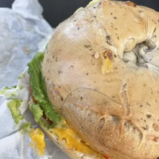 a bagel with cheese and lettuce
