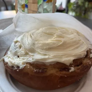 a cinnamon roll with cream frosting