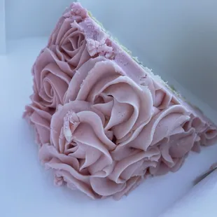 a piece of cake with pink frosting