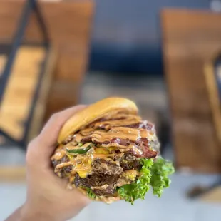 a hand holding a hamburger