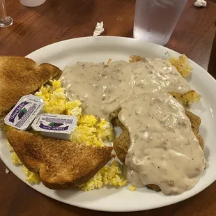 a plate of food with eggs and gravy