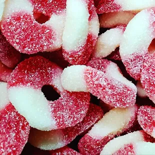 a close up of a pile of sugared donuts