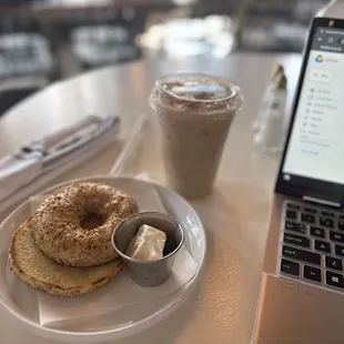 a plate of bagels and a cup of coffee