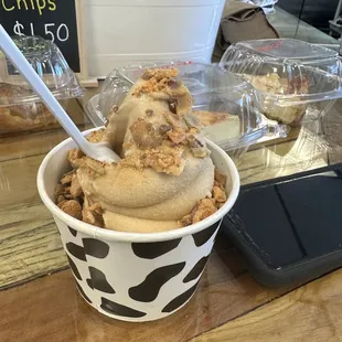 Peanut butter soft serve with waffle pieces and butterfinger pieces.