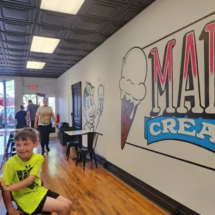 a boy sitting on a stool