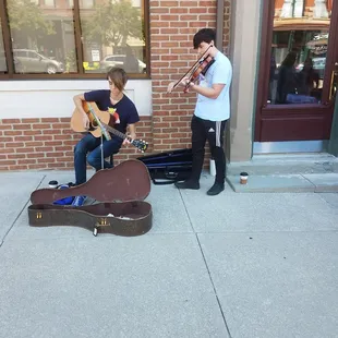 a man playing the guitar and a boy playing the violin