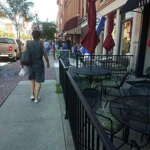 a woman walking down the sidewalk
