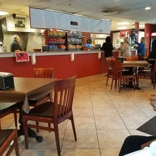 a woman sitting at a table with a plate of food in front of her