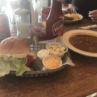 Cheeseburger, huge bowl of chili with the fixins.