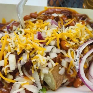 Loaded potato with chili, cheese and onions