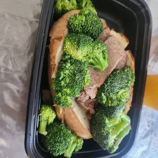 Baked potato with tri tip and broccoli.