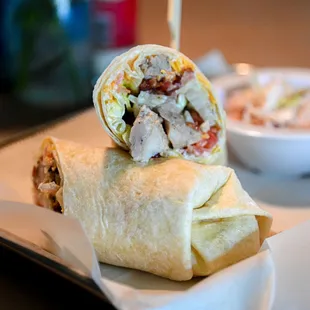 a burrito and a bowl of coleslaw